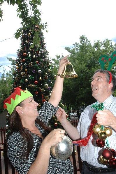 Dubbo councillors Tina Reynolds and Peter Bartley strive for some Christmas spirit yesterday in Macquarie Street