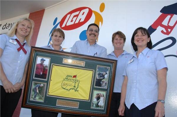 IGA representatives Lynne Whitla (South Dubbo), Bernadine Taylor (Warren), Henry Jom (West Dubbo), Chris Welch (TrangIie) and Ann Sutton (Coolah) with the signed, mounted and framed Phil Mickleson Augusta flag.