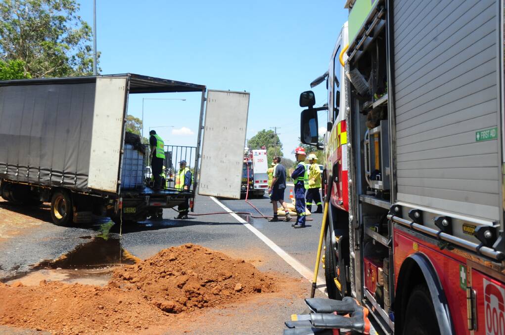 Dubbo Fire and Rescue and HAZMAT crews work to clean up a molsses spill on the Mitchell Highway yesterday, near Orana Mall. Photo: BELINDA SOOLE
