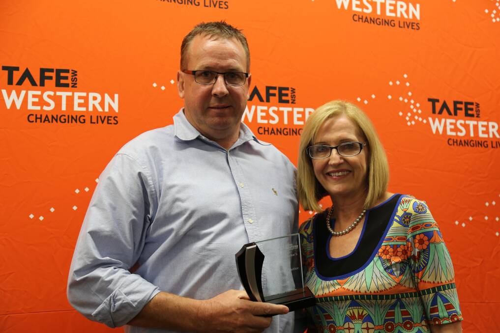 Peter Allen is presented his award by TAFE NSW managing director Pam Christie at a ceremony last Thursday night.