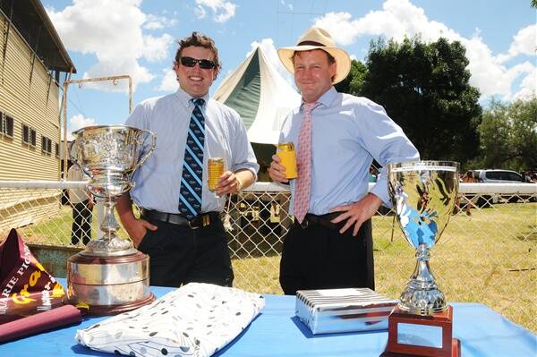 Tom Quigley and Richie Purseglove take a break from one field to head to enjoy another at the Trangie picnic races.