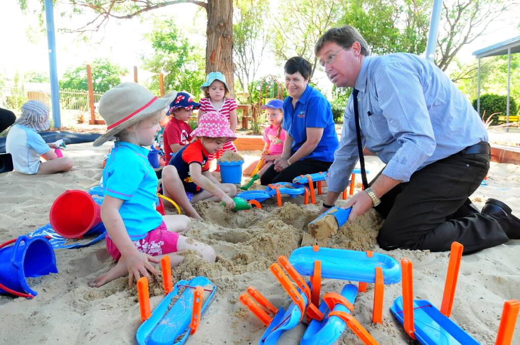 After delivering a cheque for $825,360 to Dubbo and District Preschool yesterday, Dubbo MP Troy Grant joined (from left) Kate Pankhurst, Keirsten Bennett, Cooper Giddings, Amy Quilty, Isabel Smith and preschool director Louise Simpson in the sandpit. Photo: LOUISE DONGES