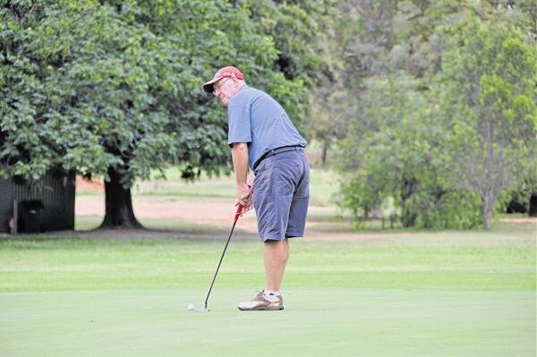 Ray Mills is a picture of concentration on the 18th green.