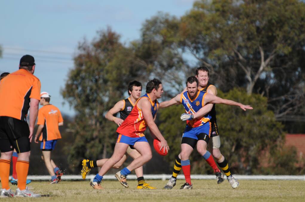 DSC  
 
Dubbo Demons captain-coach Kim Woodman in a defence role during the 2013 season. He's been reappointed to take the club to a new level this year in the Central West AFL. Photo: JOSH HEARD.