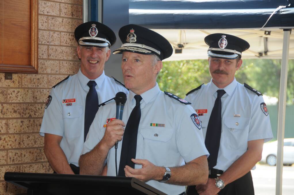 Commissioner Greg Mullins (speaker) with chief superintendent Neil Harris and superindendent Greg LewisPHOTO: AMY MCINTYRE