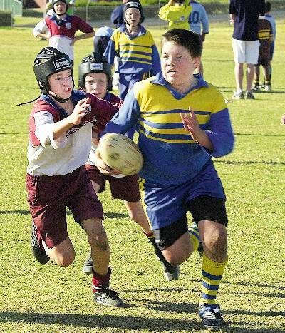 Dubbo South powerhouse runner Corey Johnson tests out the St Joseph’s, Gilgandra defence during the David Peachey Cup final for Year 5-6 boys played at Apex Oval yesterday.