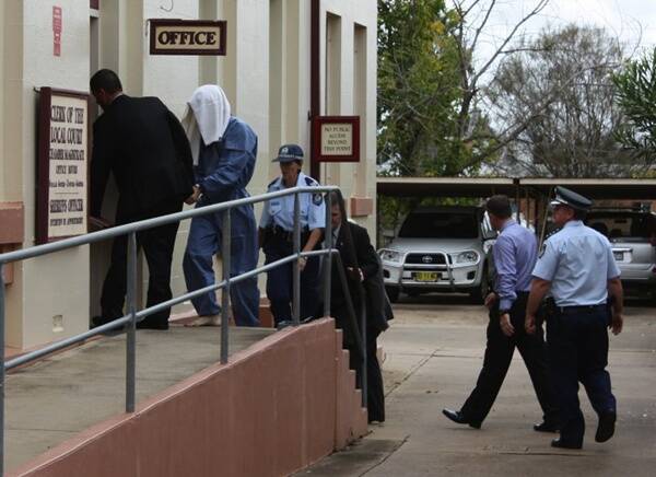 Accused murderer Luke John Cotterill is led into Mudgee Local Court.