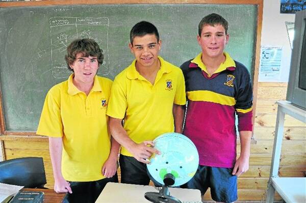 GOING PLACES: Braden Carney (centre) with fellow St John’s College students Blaike Fernando and Will Goodman checking out where the young rugby flanker is going on tour with the Lloyd McDermott squad.