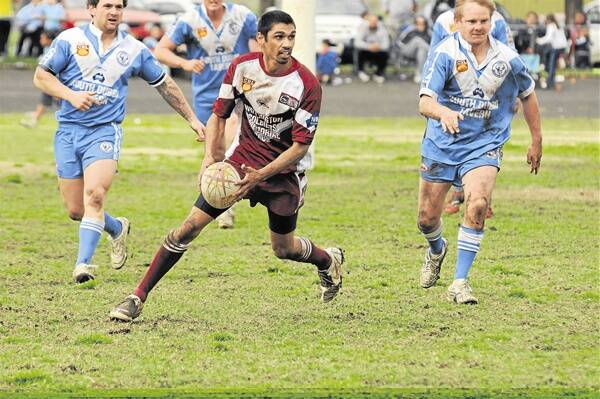 ‘Bomber’ Damien Kelly weaves his magic for the Wellington Cowboys against Macquarie Raiders.