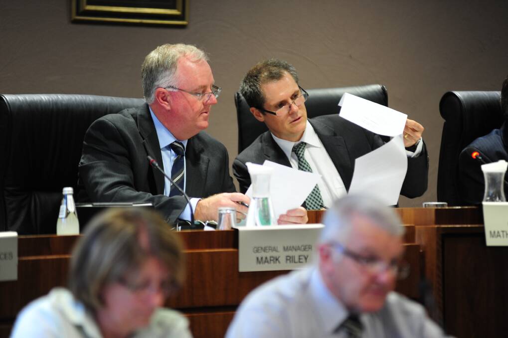 Dubbo City Council general manager Mark Riley and mayor Mathew Dickerson confer at Monday's meeting, where it was resolved to seek $1 million for the Old Dubbo Gaol.							     Photo: BELINDA SOOLE