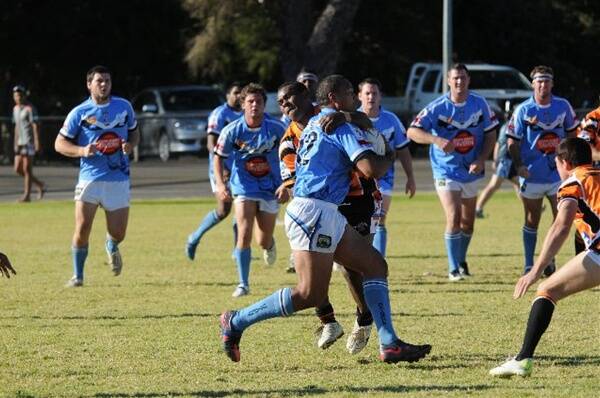 It may not be the most legal approach but Nyngan’s Semesa Cadrakilagi tries to stop Moses Manu’s progress during Macquarie’s 28-18 win on Sunday. 					                   Photo: JOSH HEARD