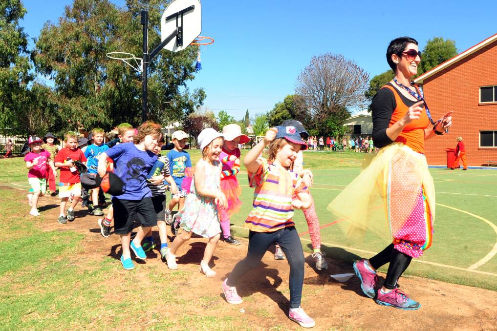 St Laurence's Primary School teacher Claire Hargreaves leads children in the Relay for Addi at the school earlier this week. The school is rallying behind the Knaggs family whose youngest daughter Addi is battling cancer. Relay for Addi raised more than $3000 to kick-start the Knaggs Travel Fund at Gilpin Travel. Full story and pictures page 7. Photo: BELINDA SOOLE