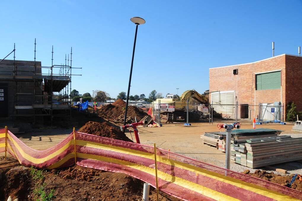 A crane heads towards the old boiler house on the redevelopment site at Dubbo Hospital. Photo: BELINDA SOOLE