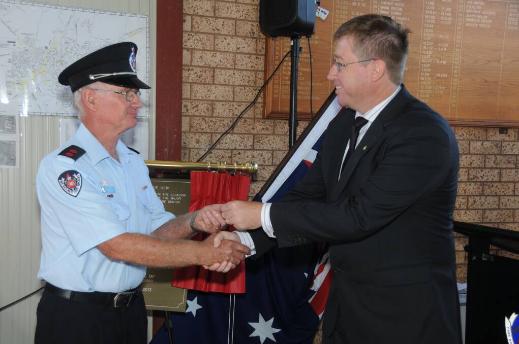 Dubbo MP Troy Grant handing over the keys to the new Delroy Fire Station to captain Bernie ReidPHOTO: AMY MCINTYRE