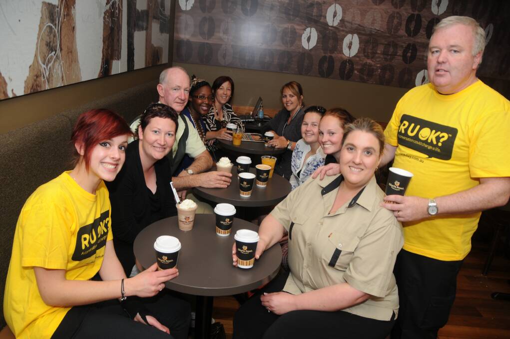 New owners of Gloria Jean's Coffees in Dubbo Donna and Steve Bicket (right) help Western NSW Local Health District staff get ready for today’s R U OK? Day. They are (from left) Marcella Bulic, Donna Parkes, Neil Frazer, Yvonne Muyambi, Leanne Frost, Sonya Warwick, Elissa Magner and Camilla Kenny. Photo: AMY MCINTYRE