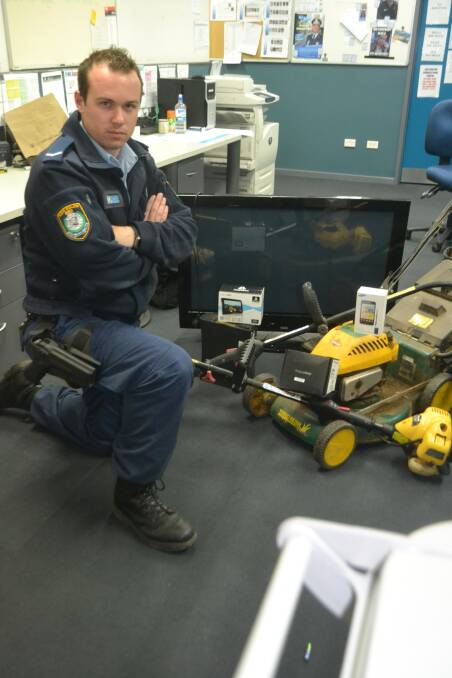 Constable Tom Cambourn with a number of goods recovered from the operation. Photo WELLINGTON TIMES