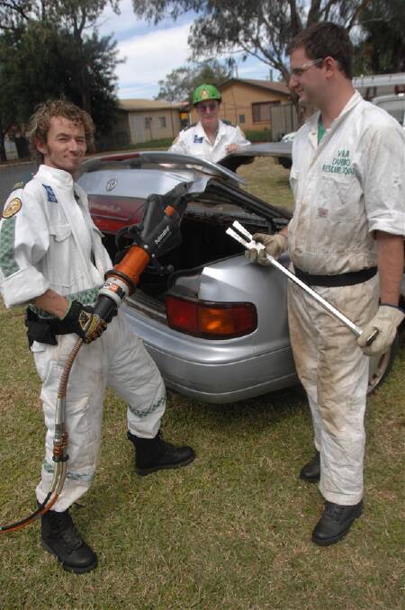 Anthony McEachern, Bob Burt and Andrew Bagnall get ready to cut up a car.