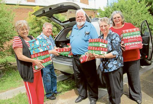 GRENFELL: Helping out with loading some of the 452 Christmas Boxes for this year to be shipped out to those in need were Stella Copeman, Jim Neill, Lloyd Thomas, Marion Knapp and Chris Simpson.