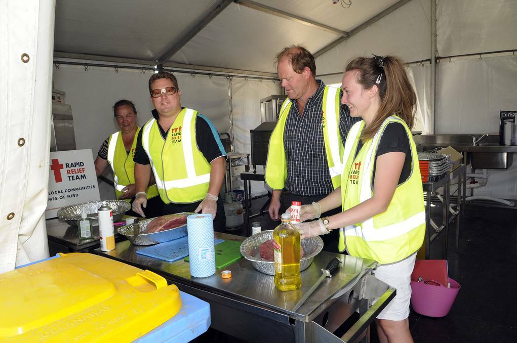 BATHURST: Making a start on preparing meals for 200 exhausted firefighters are volunteer members of the Plymouth Brethren’s Rapid Relief Team (left to right): Helen Kennard, Nigel Crow, Andrew Allbutt and Marcie Crow. Photo: PHILL MURRAY 012114prapid3
