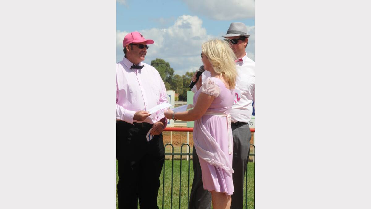 Tracy Bevan presents an award to the winner of the men's Fashions on the Field