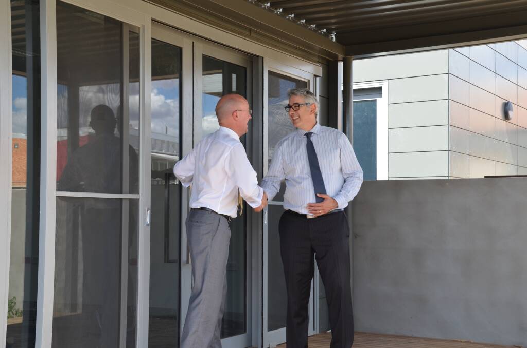 Western NSW Local Health District director of Mental Health and Drug and Alcohol Service Dr Russell Roberts greets Arthur Papakotsias, chief executive officer of Neami Limited. 