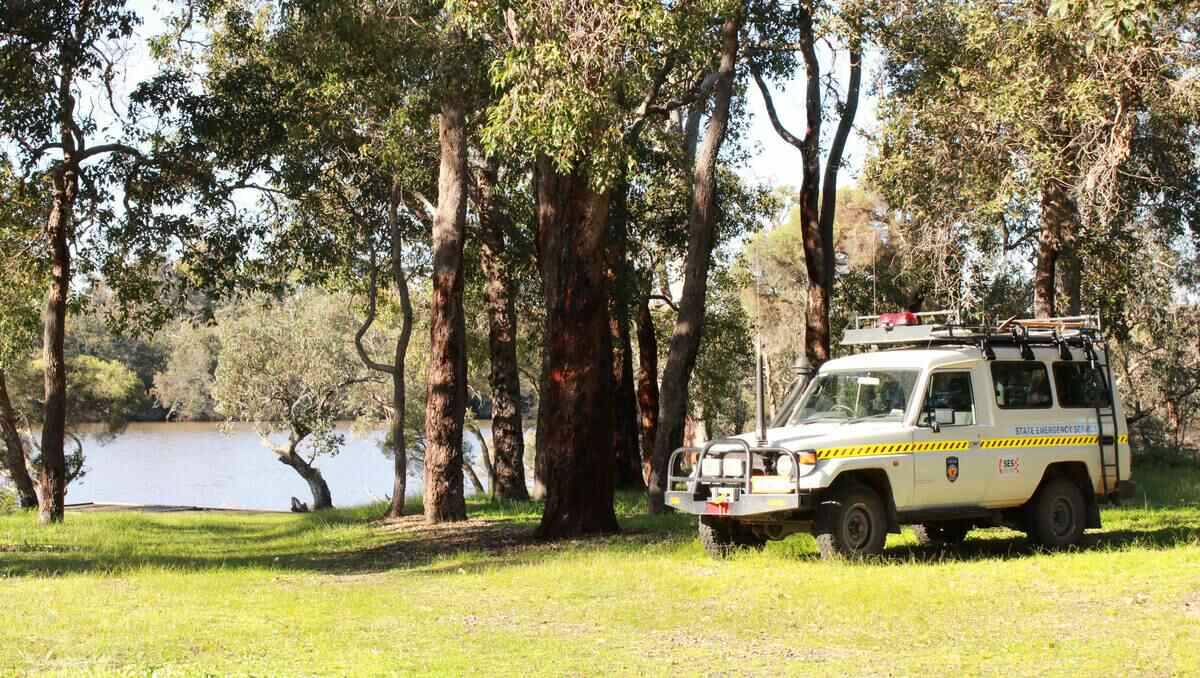 SES volunteers search along the Collie River for missing teenager Joshua Mcleod.