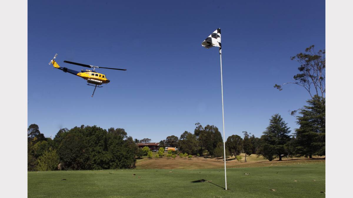   Water bombing helicopters fill up at Springwood Golf Course.  PHOTO: GEOFF JONES .