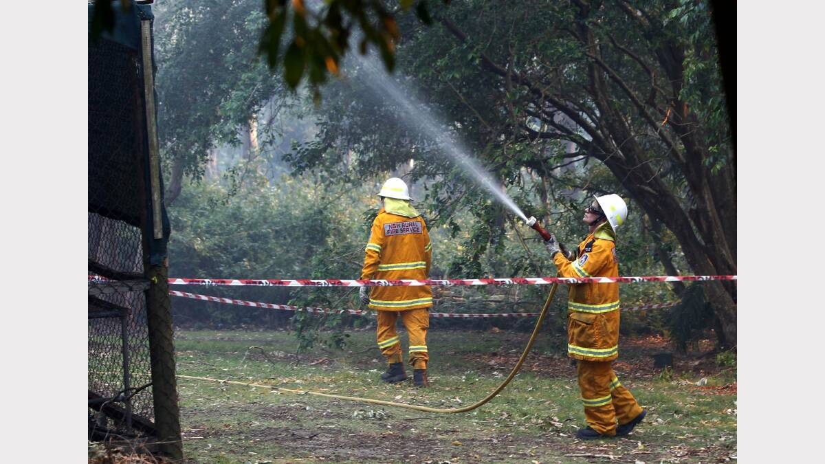   Fire at Dudley. Image shows fire crews hosing down the Awabakal learning centre. Picture by Darren Pateman