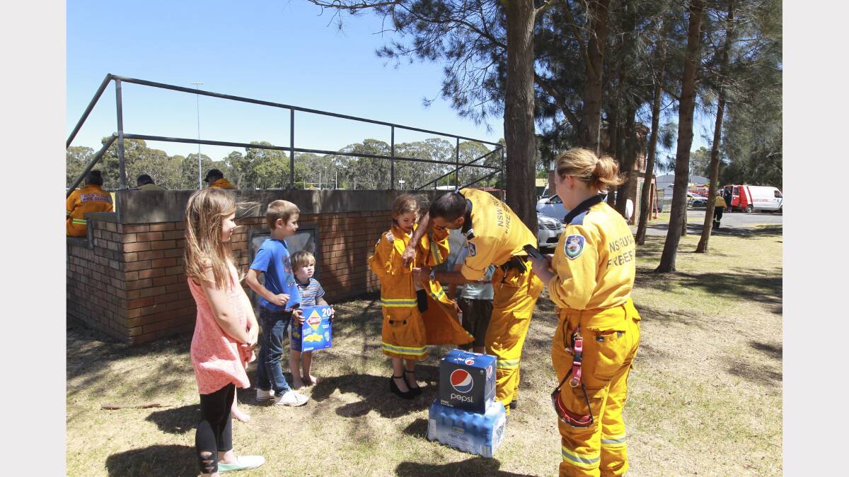  Firefighters at Bargo Oval in the Southern Highlands accept food donated by the Bennett family today.