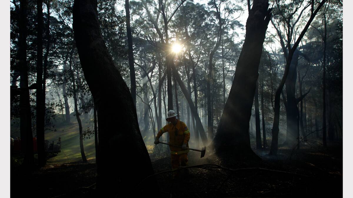  RFS crew from Kurrajong Brigade work to extinguish a fire which has flared up around the State Mine fire near Berambing. Photo: Wolter Peeters