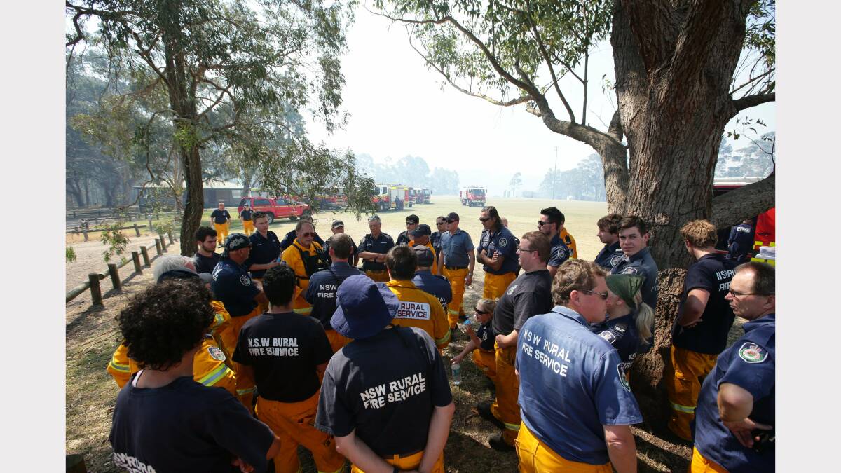   Scenes from around Minmi.  Rural Fire Fire service members prepare for action at Minmi. This is a staging area Minmi Sportsground next to the evacuated public school.  Picture by Peter Stoop