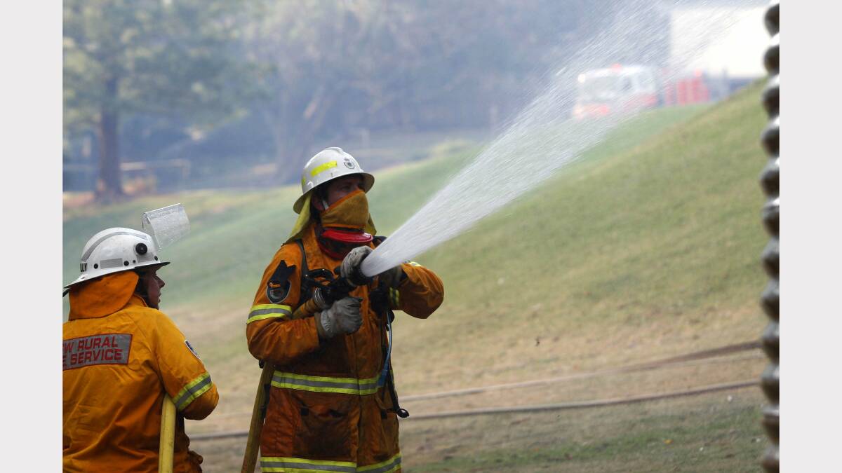  Fire at Dudley. Image shows fire crews hosing down the Awabakal learning centre. Picture by Darren Pateman