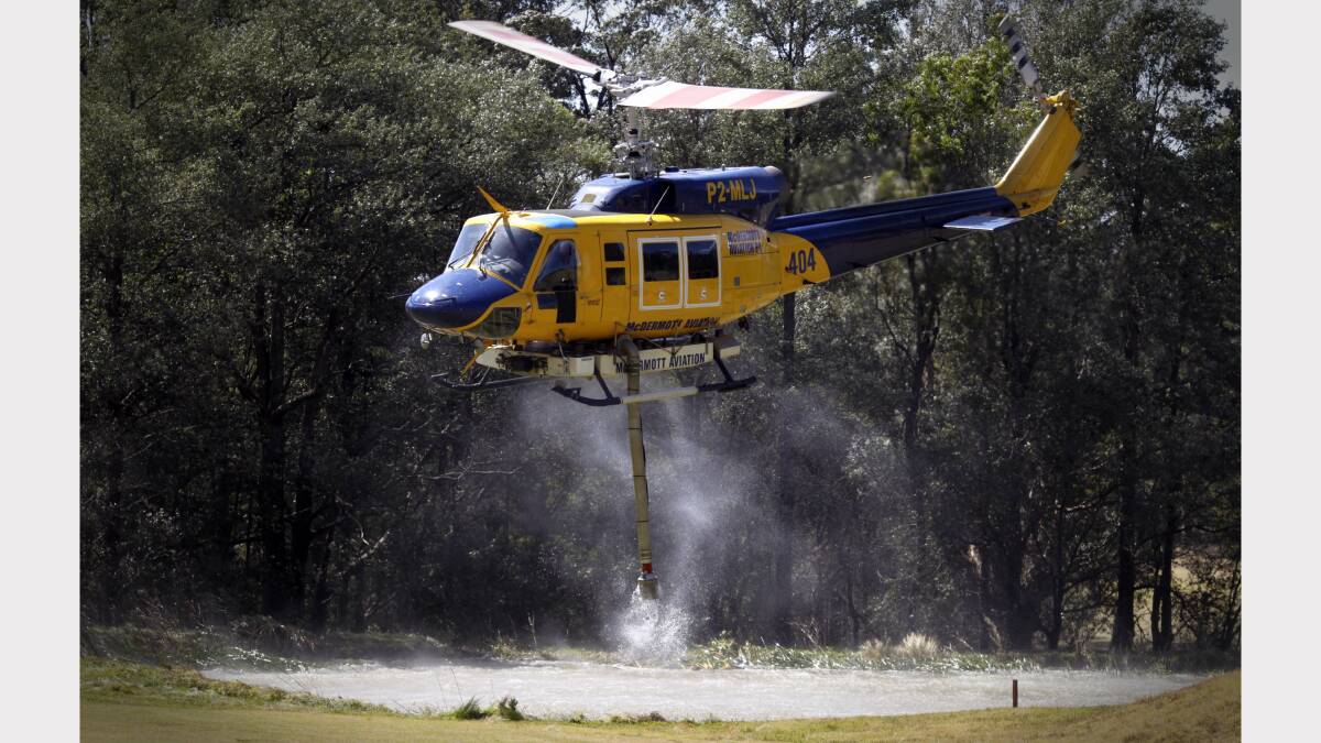  Water bombing helicopters fill up at Springwood Golf Course.  PHOTO: GEOFF JONES .