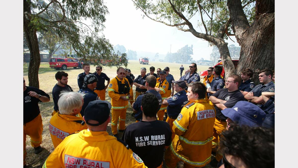  Scenes from around Minmi.  Rural Fire Fire service members prepare for action at Minmi. This is a staging area Minmi Sportsground next to the evacuated public school.  Picture by Peter Stoop