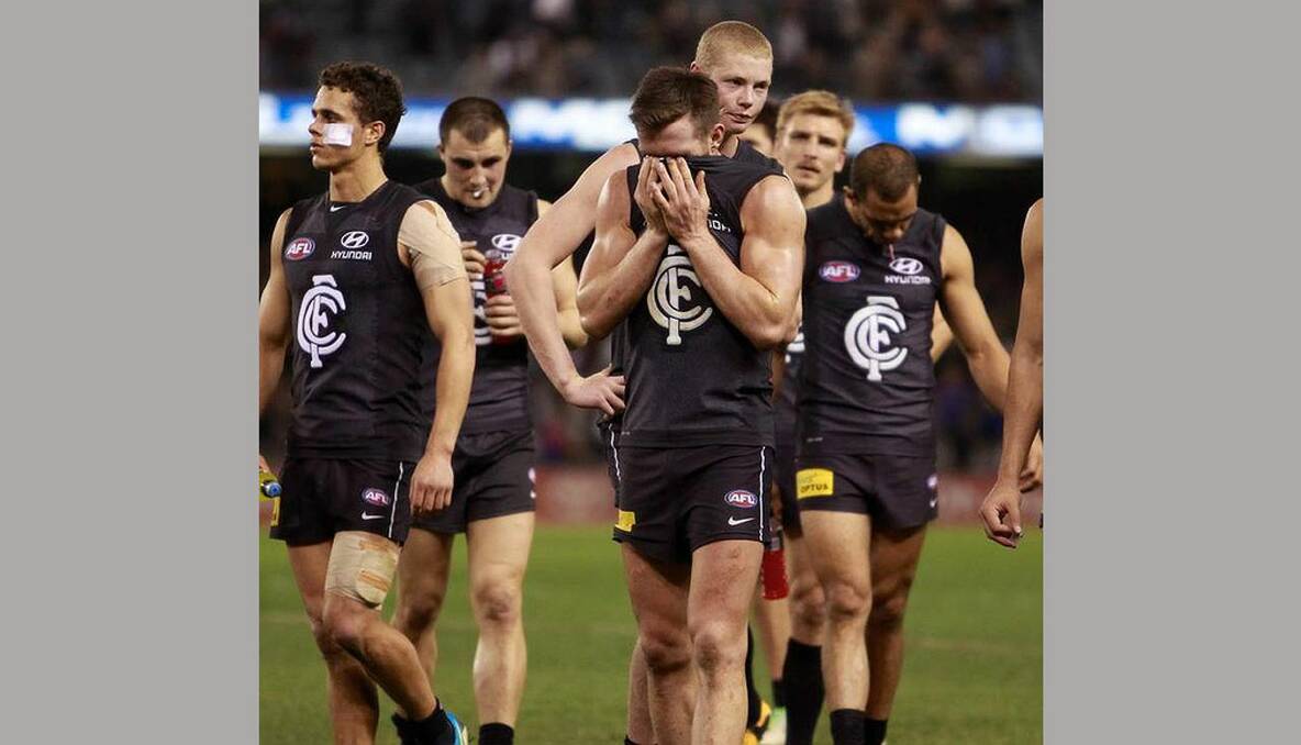 A dejected Carlton team leaves the ground after being defeated by the Western Bulldogs. Photo: Justin McManus
