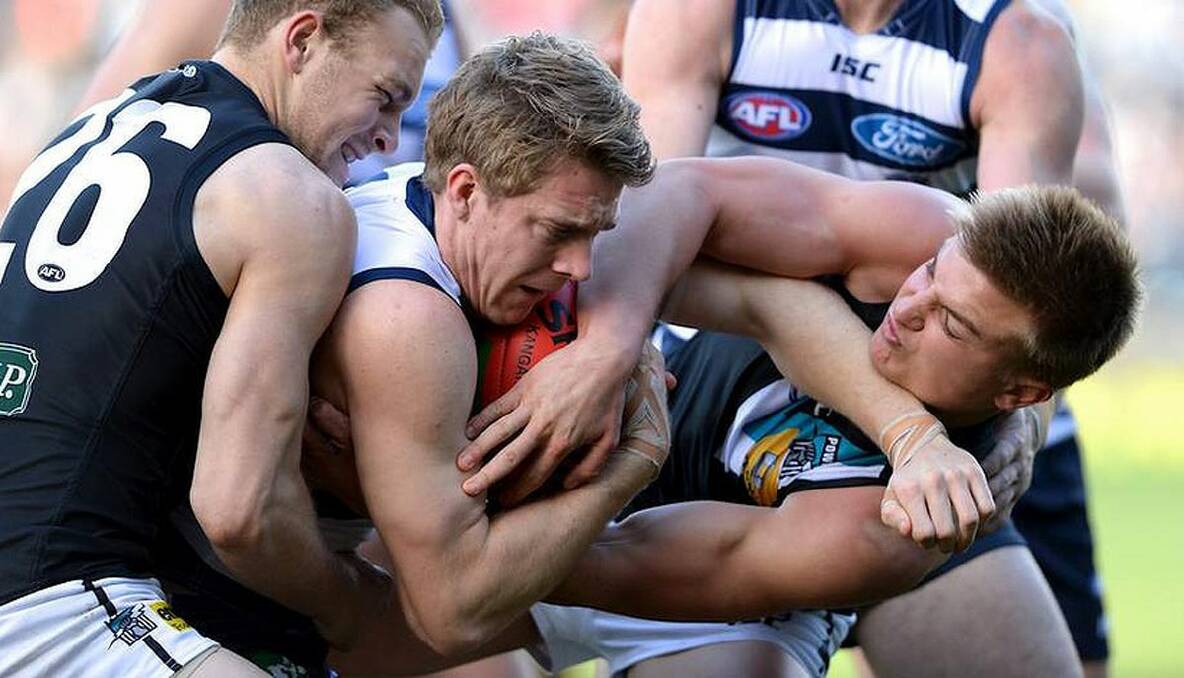 Geelong v Port Adelaide. Cameron Guthrie is wrapped up by Andrew Moore and Oliver Wines. Photo: Pat Scala 