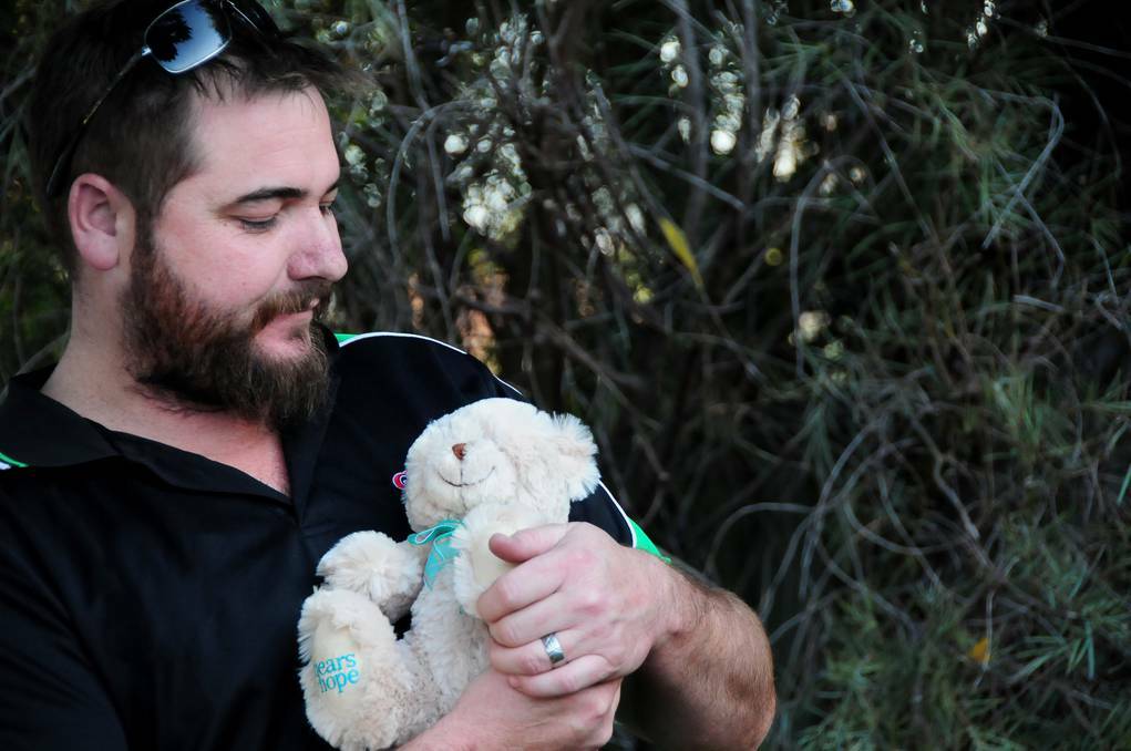 DUBBO: Dubbo father Mathew Muller holding a Bears of Hope teddy bear given to support grieving parents. Photo: LOUISE DONGES