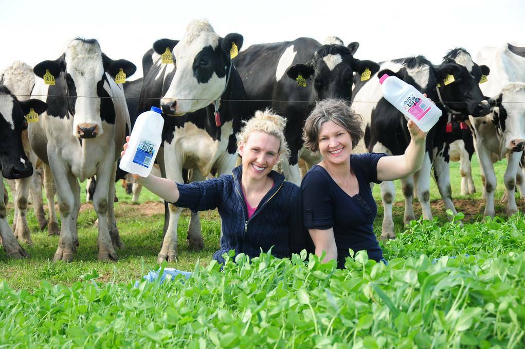 DUBBO: Emma Elliott and her mother Erica Chesworth out with the cows on the Little Big Dairy Co. Photo: LOUISE DONGES