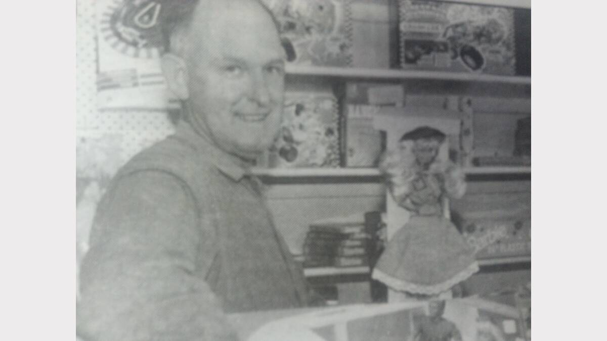 Dubbo toy store proprietor John Bassingthwaite with an all-time favourite, the Barbie doll.