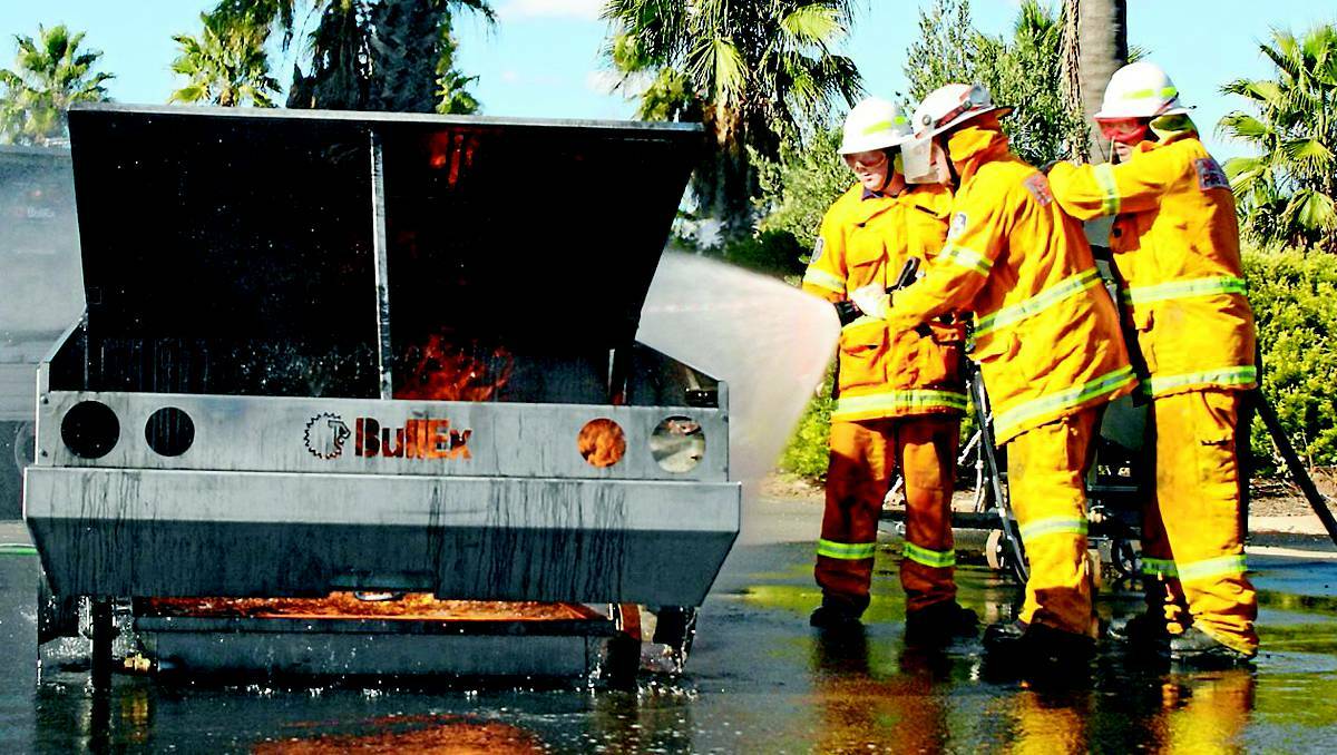 MUGEE: Rural Fire Services members demonstrate how a car fire can be controlled, using equipment provided by BullEx Australia at the Rural Fire Service Association (RFSA) biennial conference at Parklands Resort on Saturday.