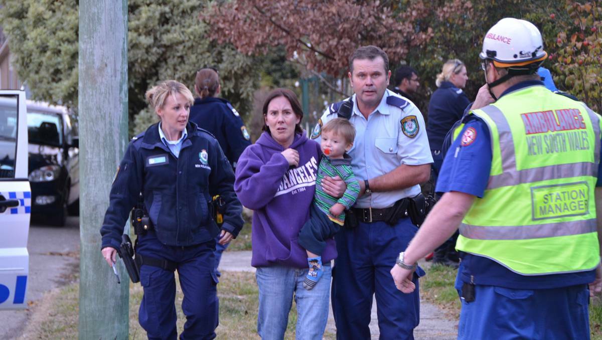 LITHGOW: Police officers handed over a toddler and his mother to paramedics after they were removed from harm’s way at an Inch Street house fire on Wednesday.