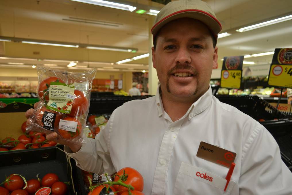 Coles' fresh produce manager Aaron Russell and his "bad boy" will add to proceeds from tomatoes being donated to Movember. Photo: PHILIP LY
