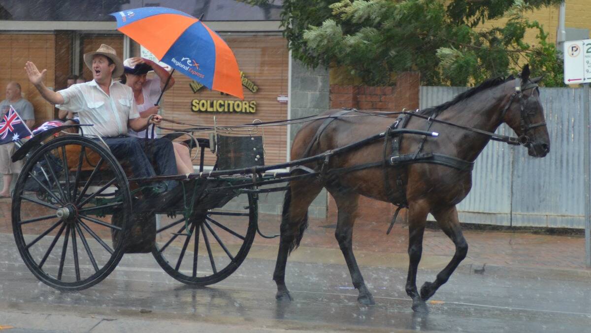 Community members were caught in the rain during the Forbes Australia Day parade. Twenty-six millimetres was recorded   at Forbes Airport on Australia Day.