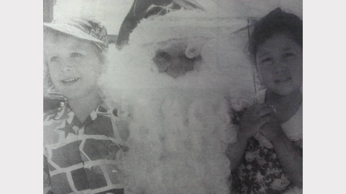 Joel Kruss and Cherise Johnson with Santa. 