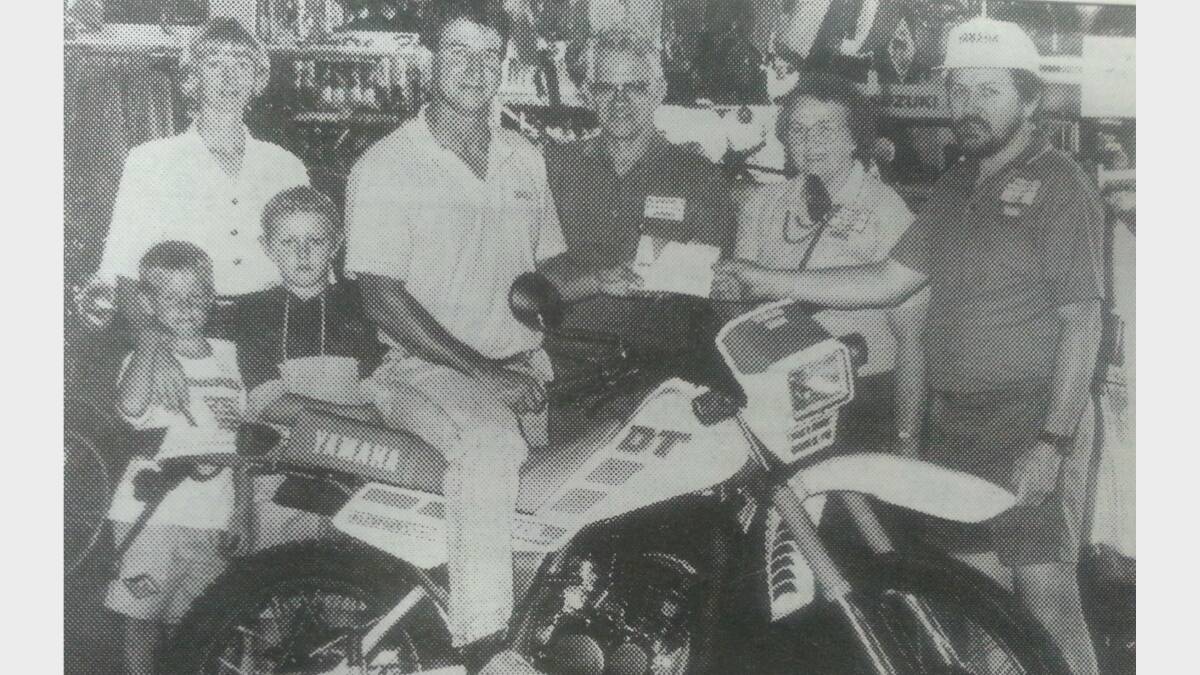 #TBT JANUARY 1993: Redfords Motorcycles Christmas competition winner Steve Albert, wife Debbie and children Lee (6) and Jason (7) with the prize being handed over by Dick, Cilla and David Readford. 
