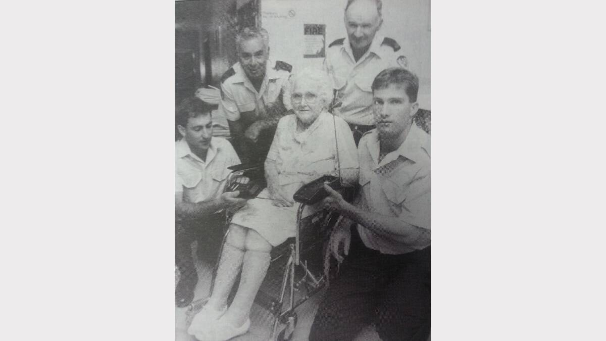 A new photo for the nursing home was a reason to celebrate. Fire brigade members Mark Rich, John Howey, Bernie Reid and Ducan Towart show Elenor Cansdell how to use it.