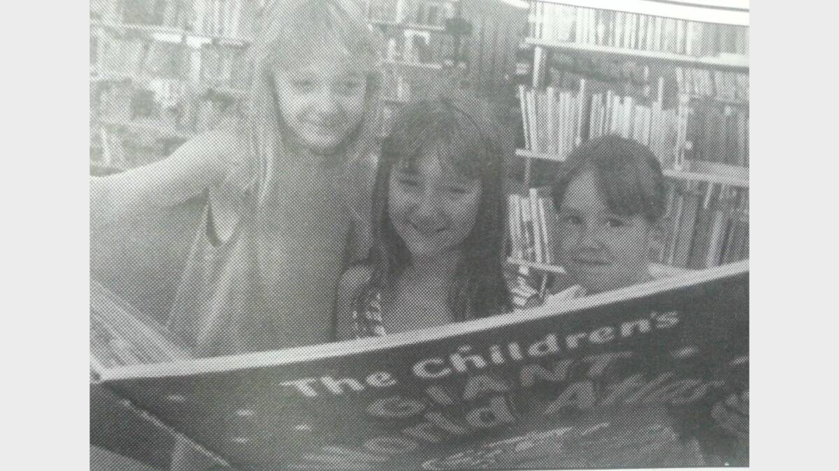 #TBT JANUARY 1993:  Amy (7), Peta (10) and Lisa (4) McGuinness got into some holiday reading at the Macquarie Regional Library. 