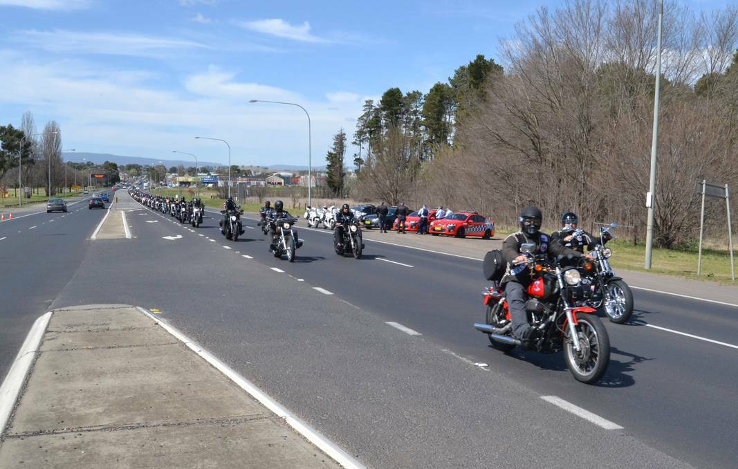 BATHURST: Members of the Rebels motorcycle gang ride through Bathurst yesterday to be welcomed by a major police presence at the Evans Bridge. 090513bwbikes 