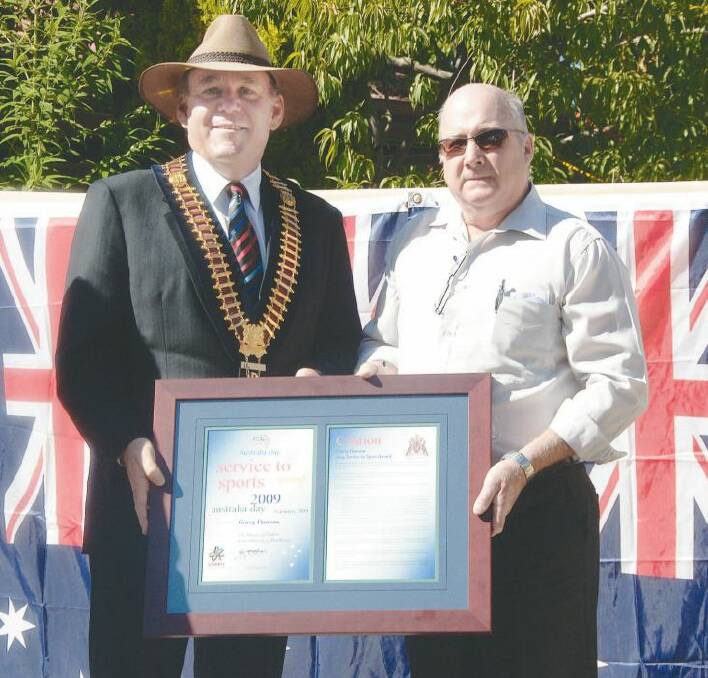 AUSTRALIA DAY HONOURS 2009: Dubbo Mayor Greg Matthews presents Dubbo Cycle Club coach Garry Dawson with the 2009 Services to Sports Award at Dubbo’s annual Australia Day ceremony held at Victoria Park yesterday