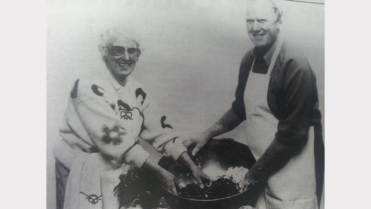 Ray and Norma Carter busily hand-mixing the tradition plum puddings.